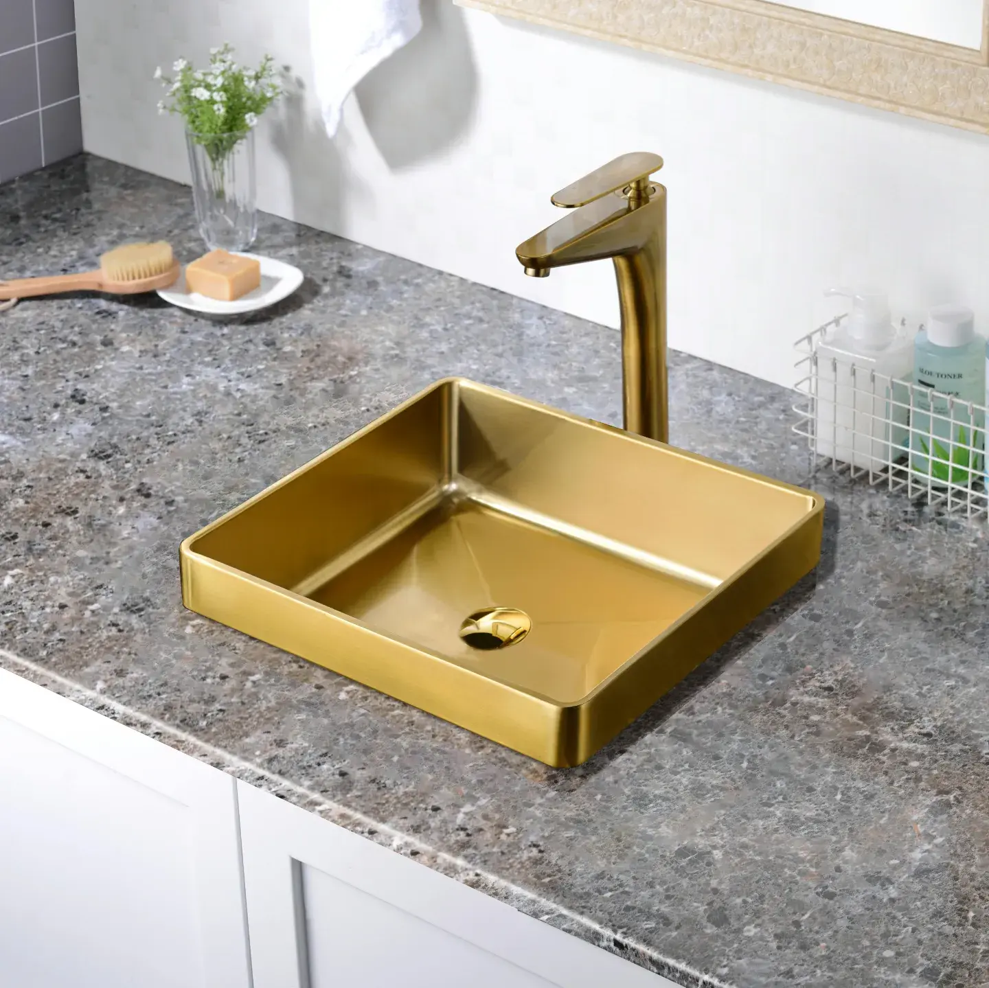 A brass vessel basin on a stone vanity